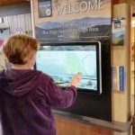 Visitor uses interactive kiosk to learn about the area.